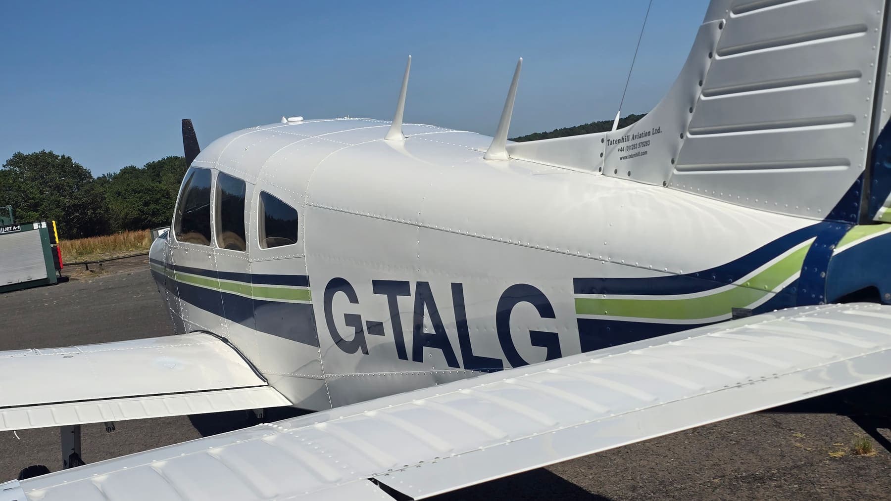 A cleaned Piper PA-28 cabin and tail with Tatenhill Aviation titles, photographed over the wing