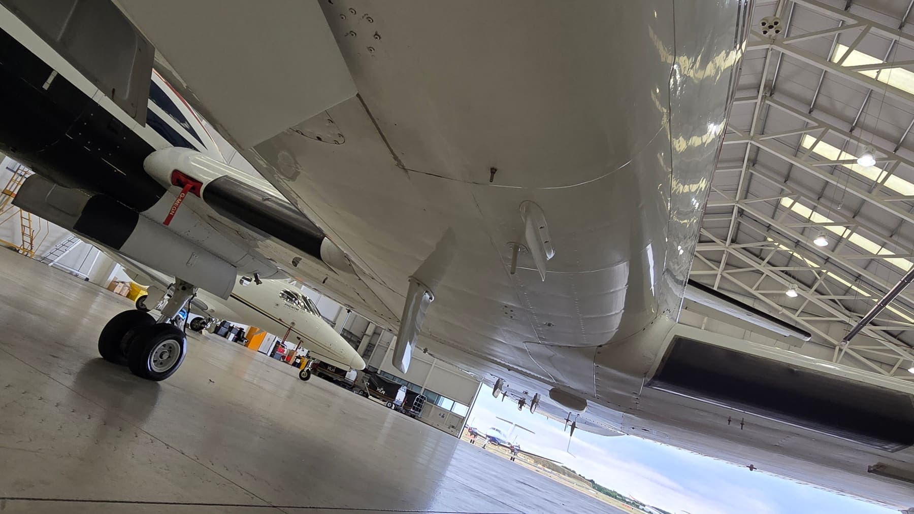 Under the belly of a King Air after degreasing — clean skins along the full underside